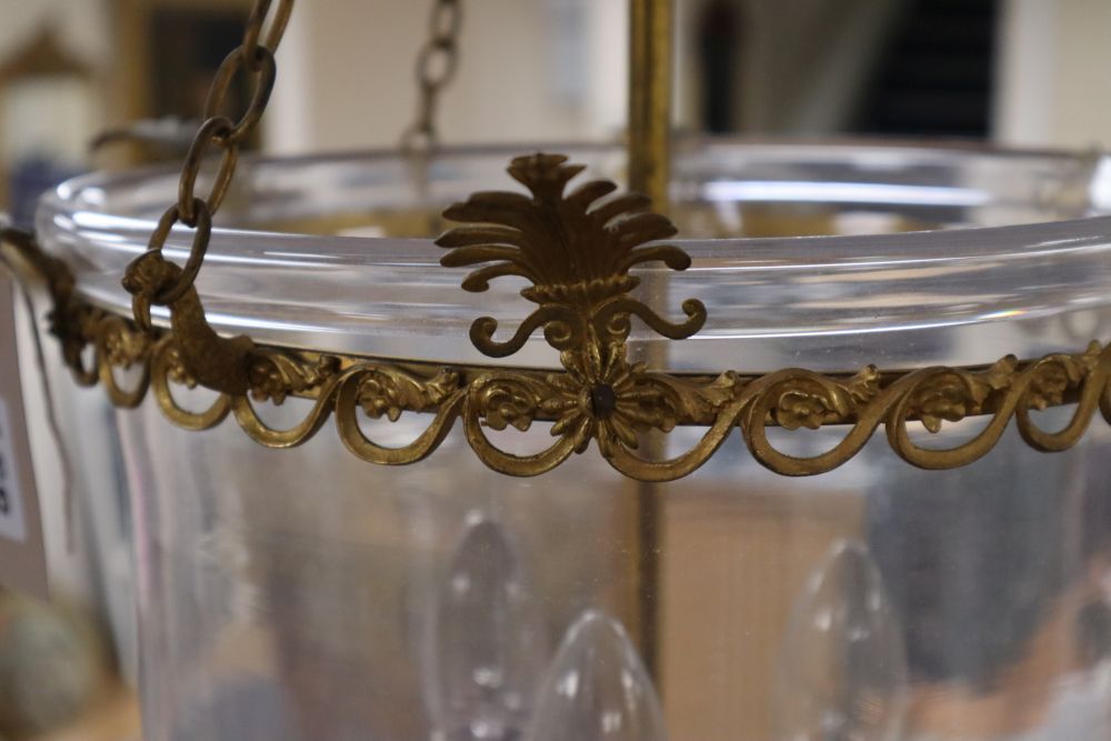 A pair of three light hall lanterns, cast with anthemions, height 63cm